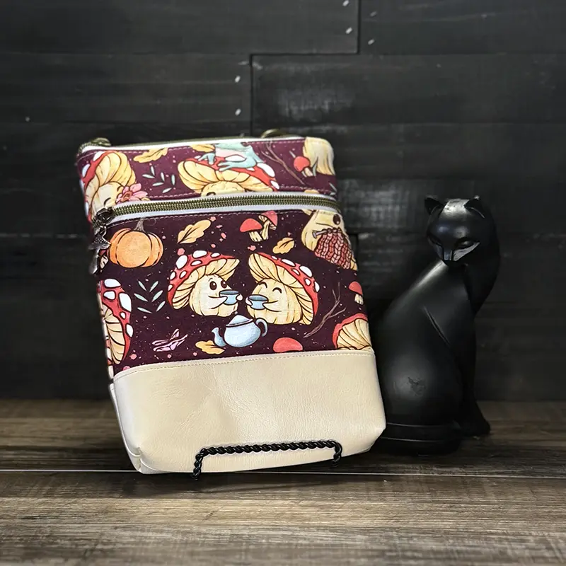 small crossbody phone bag with a wolf design in blue