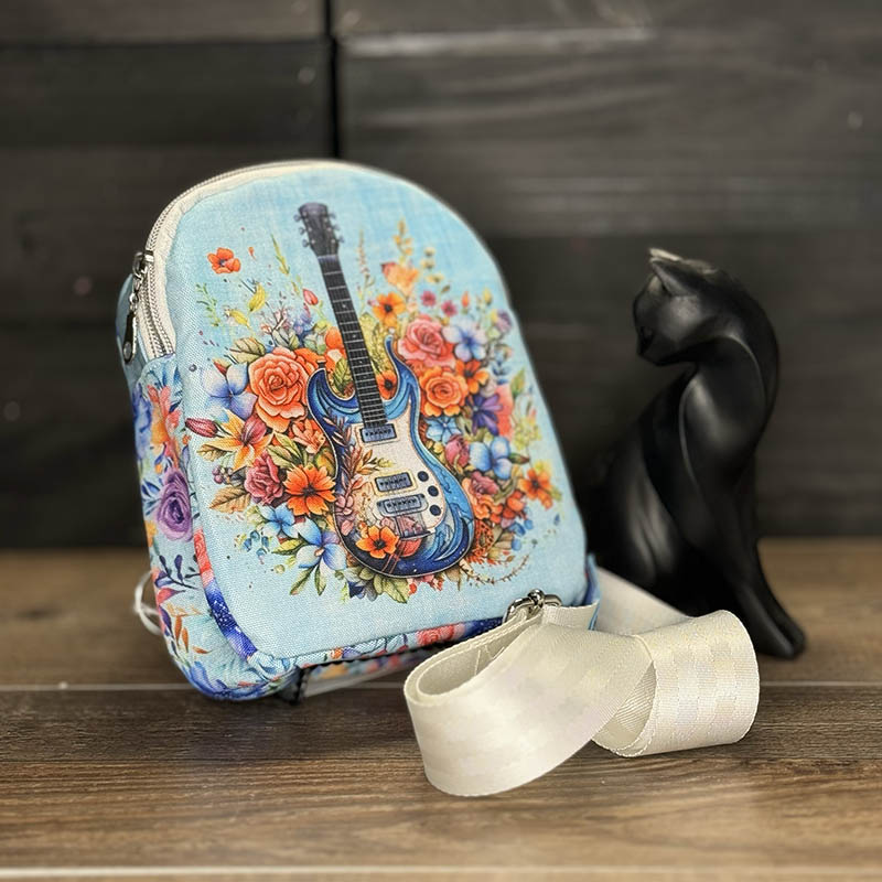 handmade mini-backback crossbody bag with a guitar nestled in a spray of flowers