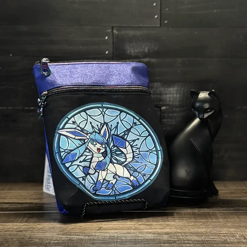 small crossbody phone bag with a wolf design in blue