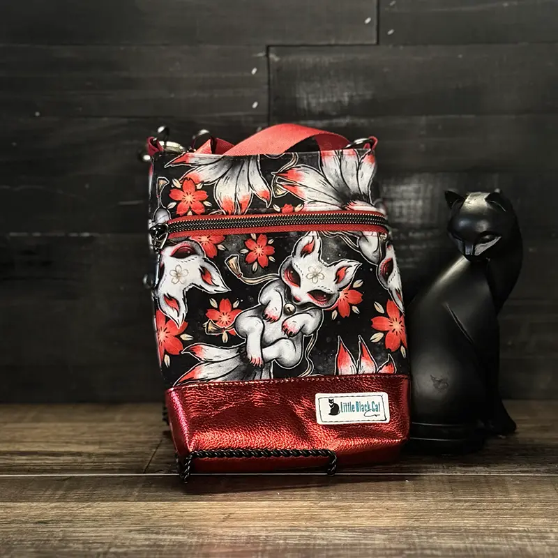 small crossbody phone bag with a wolf design in blue