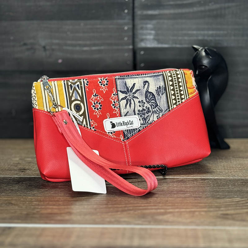 handmade wristlet featuring vintage 70s fabric with a red, white, blue, and yellow design