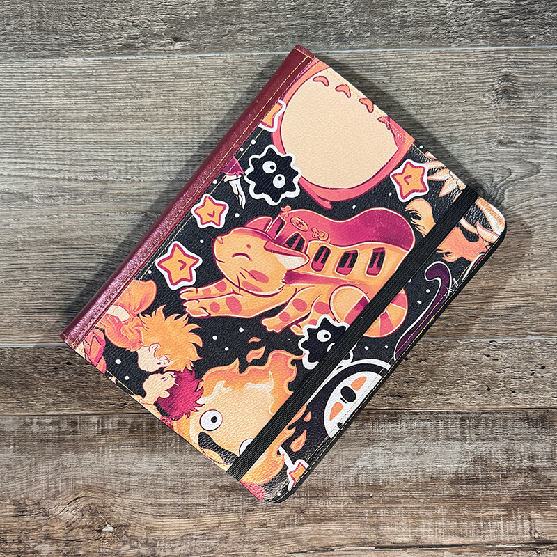 notepad holder featuring pocket monsters in pink and purple