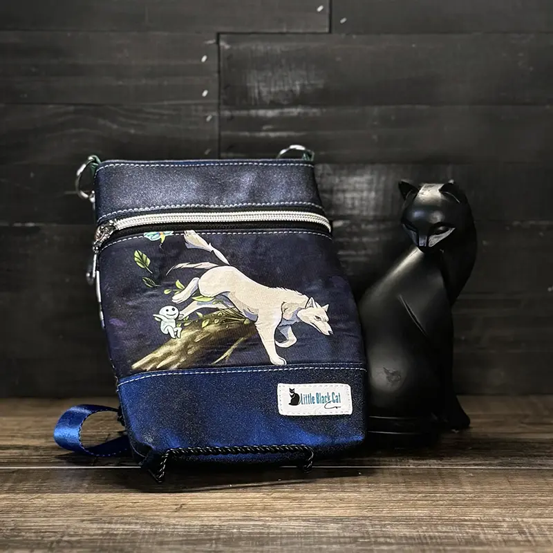 small crossbody phone bag with a wolf design in blue