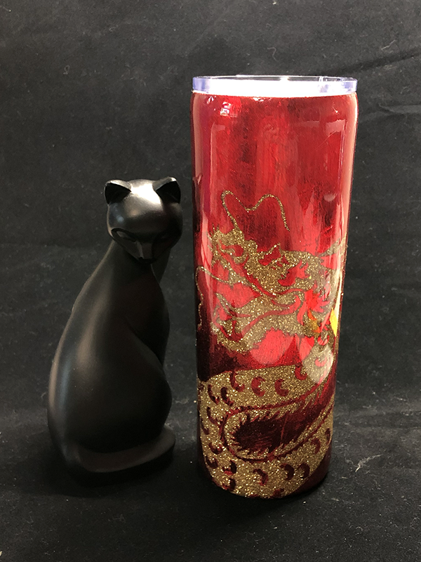 red and gold tumbler with the design of a dragon