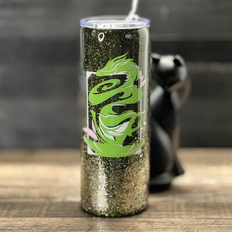 decorated 20oz steel tumbler with a teacup steaming in a shape like a dragon and dark green glitter
