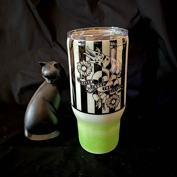 decorated 30oz steel tumbler a glow in the dark design featuring neon green glitter and a striped worm